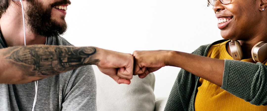 man and a woman fist bumping each other